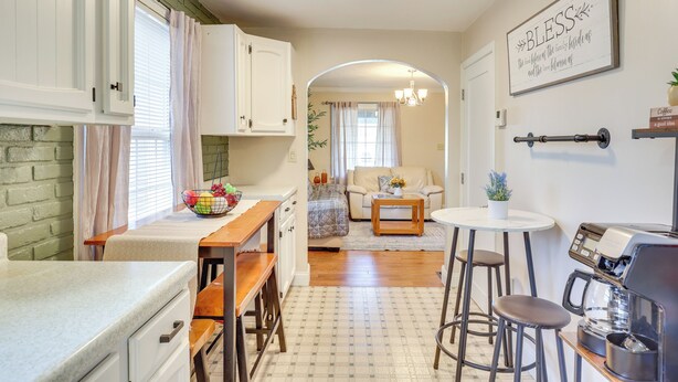 A kitchen with a dining area, a coffee machine, and a sign on the wall. - Quiet Home Base in the Heart of Boardman! (Boardman)