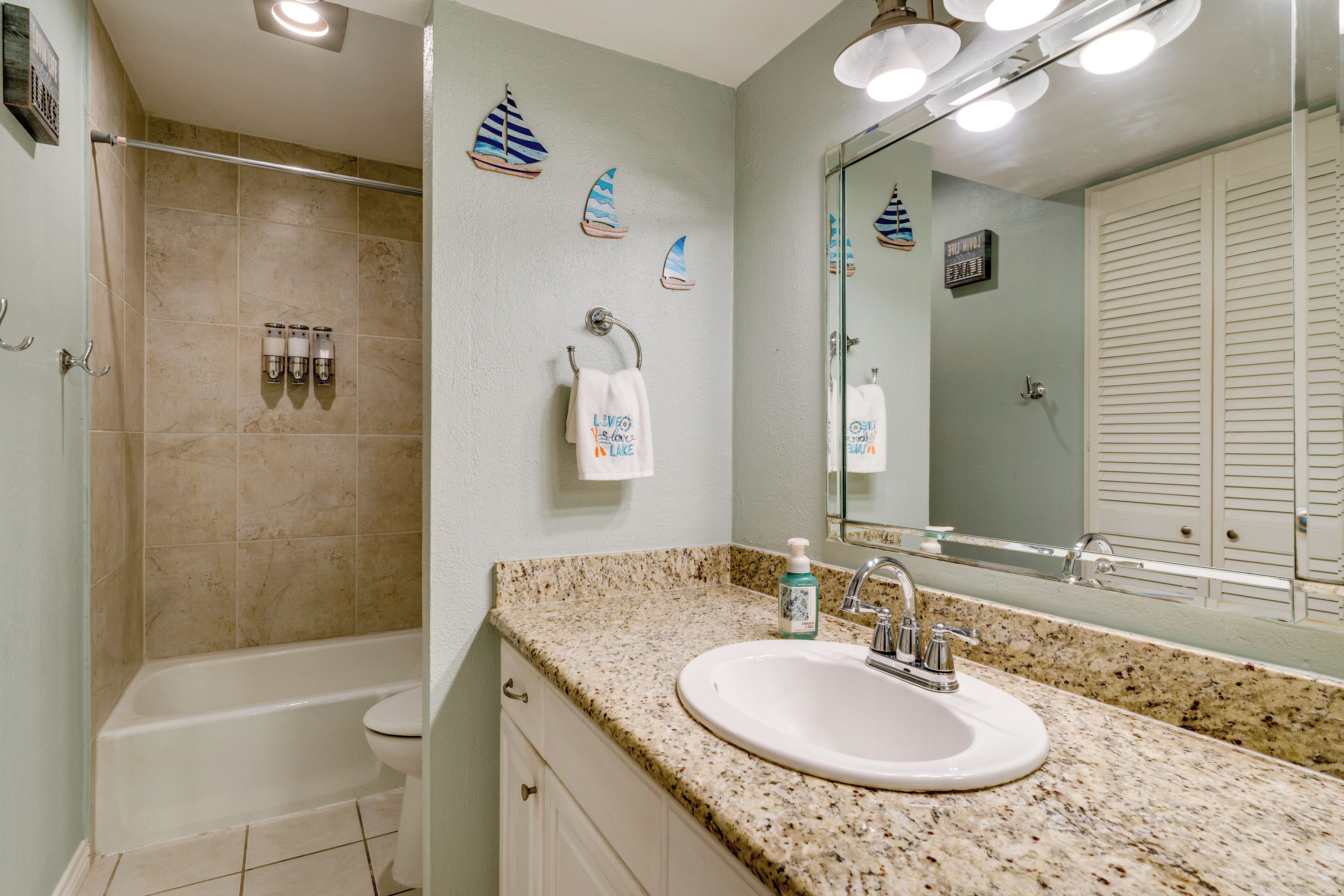A bathroom with a bathtub, a sink, and a shower.