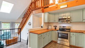 A kitchen with light green cabinets, a wooden countertop, and a stainless steel oven. - 1 Mi to Lake, Golf & Ski Access: The Hideout Home! (Lake Ariel)