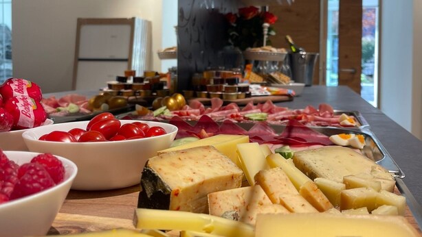 A buffet with various cheeses, fruits, and meats. - Gemmi Hotel & Spa (Kandersteg)