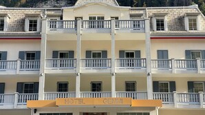 A multi-story hotel with balconies, a prominent 'HOTEL GEMMI' sign, and a mountainous backdrop. - Gemmi Hotel & Spa (Kandersteg)