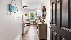 A hallway with a kitchen area, a dining area, and a living room. - 2BR near Gulf Place w/ Pool, Grill + Free Tickets: Dolphin Cruise & More! (Santa Rosa Beach)