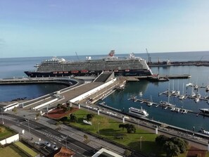 A large cruise ship docked at a port with a marina in the foreground. - Apartment in the city center with spectacular views and easy access. (Ponta Delgada)