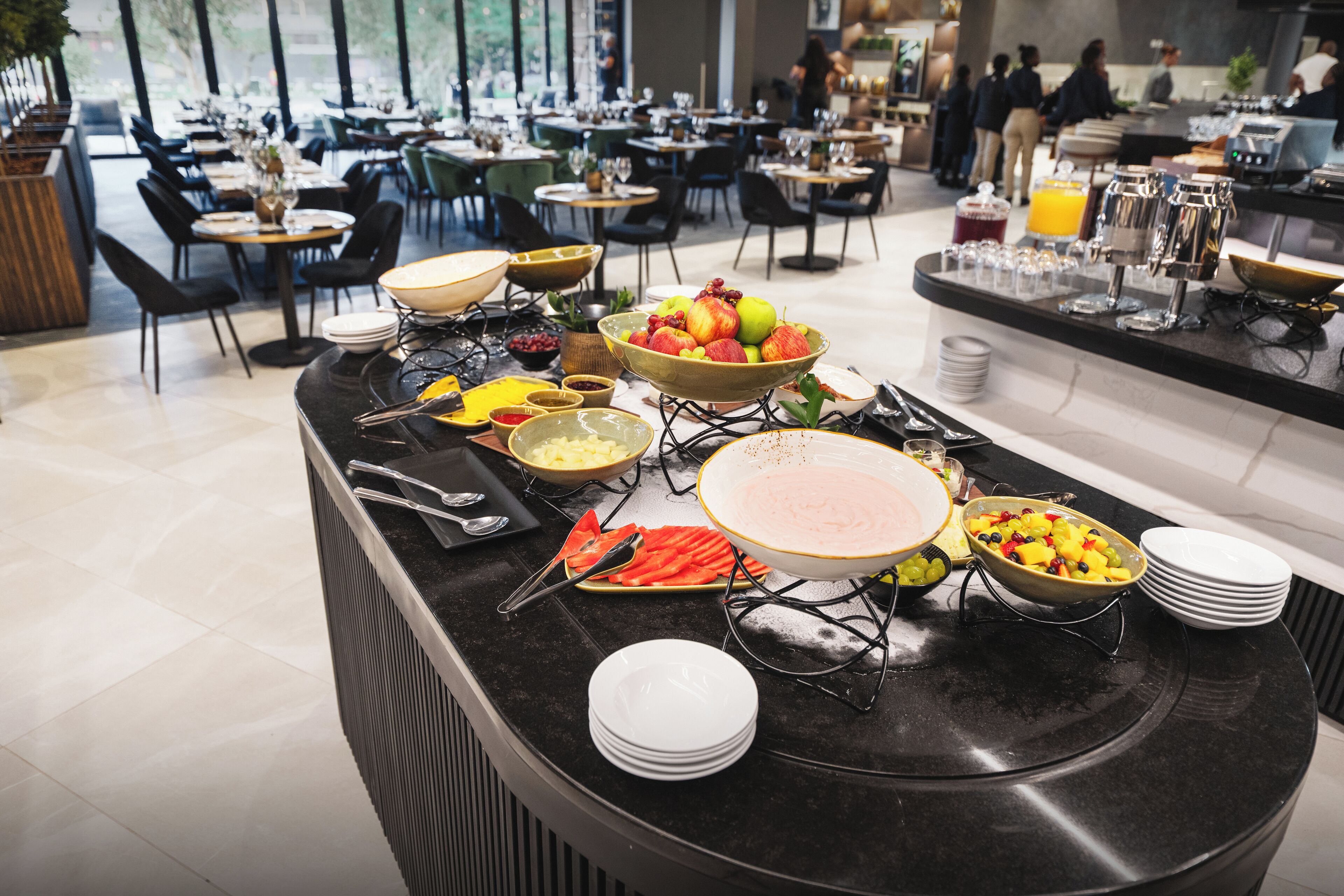 A buffet setup with various food items and utensils.