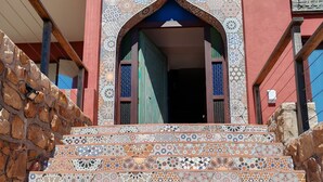 A staircase with a variety of colorful tile patterns leading to a building entrance. - Boho Ocean-View Villa: Pool & Walk to Beach (Murdock Valley)
