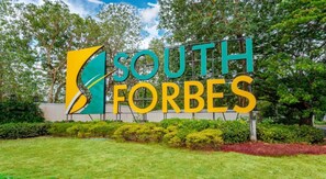 A sign with the text "SOUTH FORBES" surrounded by greenery. - Combined & Spacious Units+400mbps+Netflix+Disney (Silang)