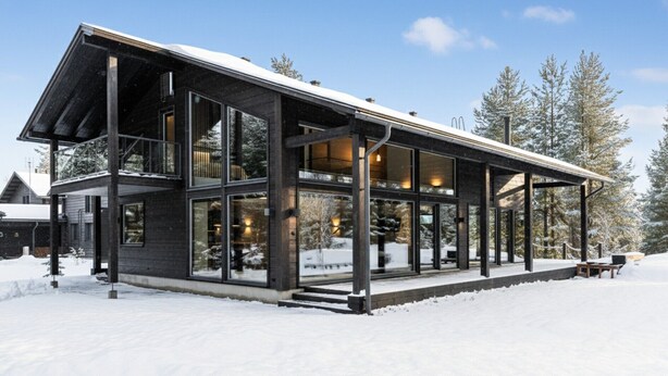 A modern, multi-story building with large windows and a covered outdoor area. - High-Quality 4BR Villa in Ruka - Private Hot Tub & Sauna (Kuusamo)