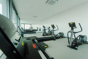 A gym with various exercise equipment, including treadmills and stationary bikes. - A Plush Studio at Loxwood House (Accra)