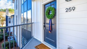 A house with a blue door, a number 259 sign, and a green wreath. - New! Shug's Station, 2 BR, 2BA condo close to Auburn University, sleeps 4! (Auburn)