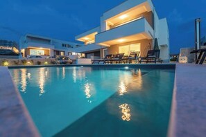 A modern two-story house with a swimming pool and outdoor seating area. - Apartment 2 (Novalja)