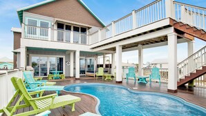 A pool area with lounge chairs and a deck. - Gulf Views | Private Pool | Outdoor Kitchen (Fort Morgan)