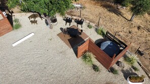An outdoor seating area with a table and chairs, surrounded by gravel and plants.