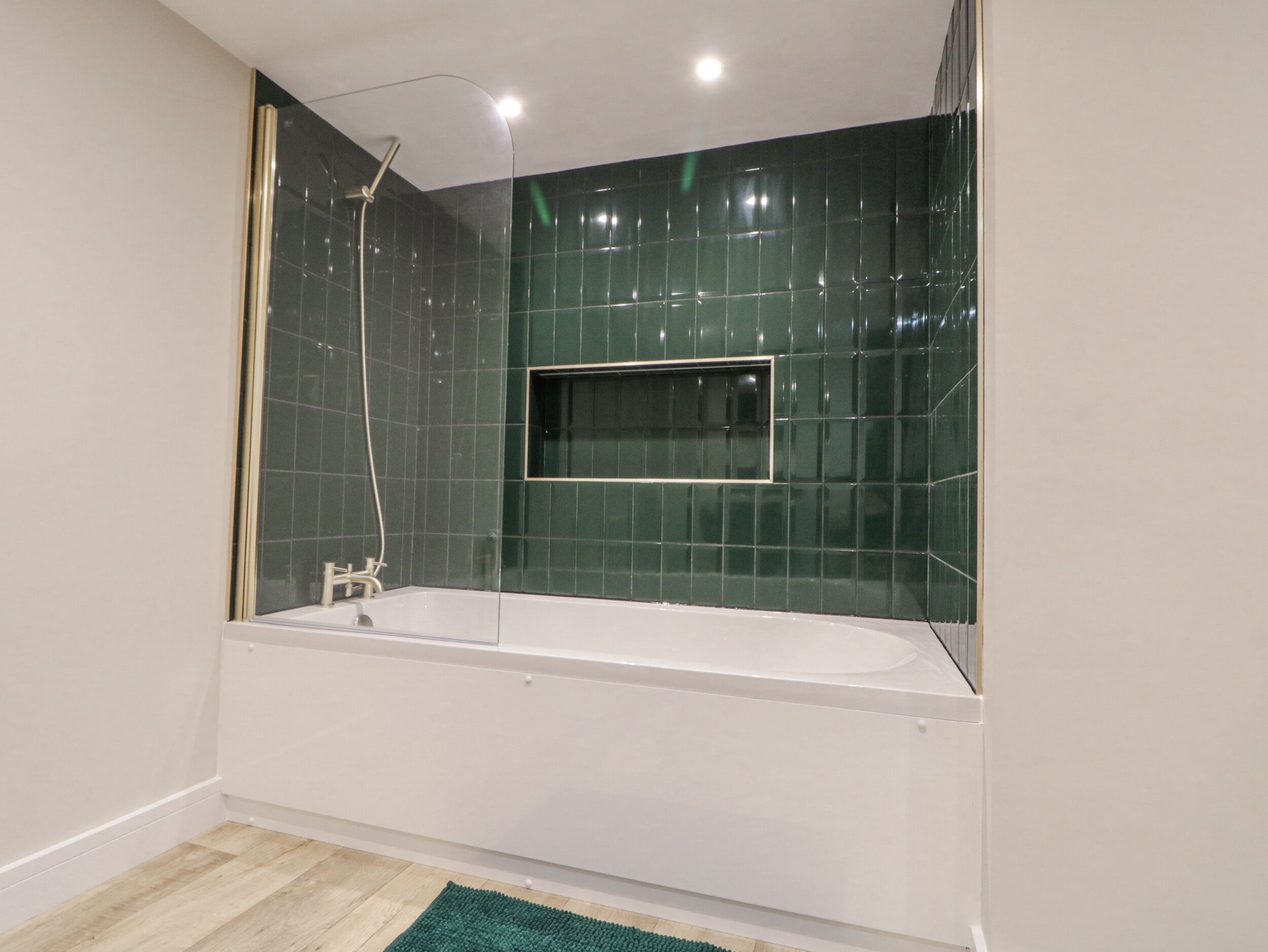 A modern bathroom with a freestanding bathtub, a shower, and a large mirror.
