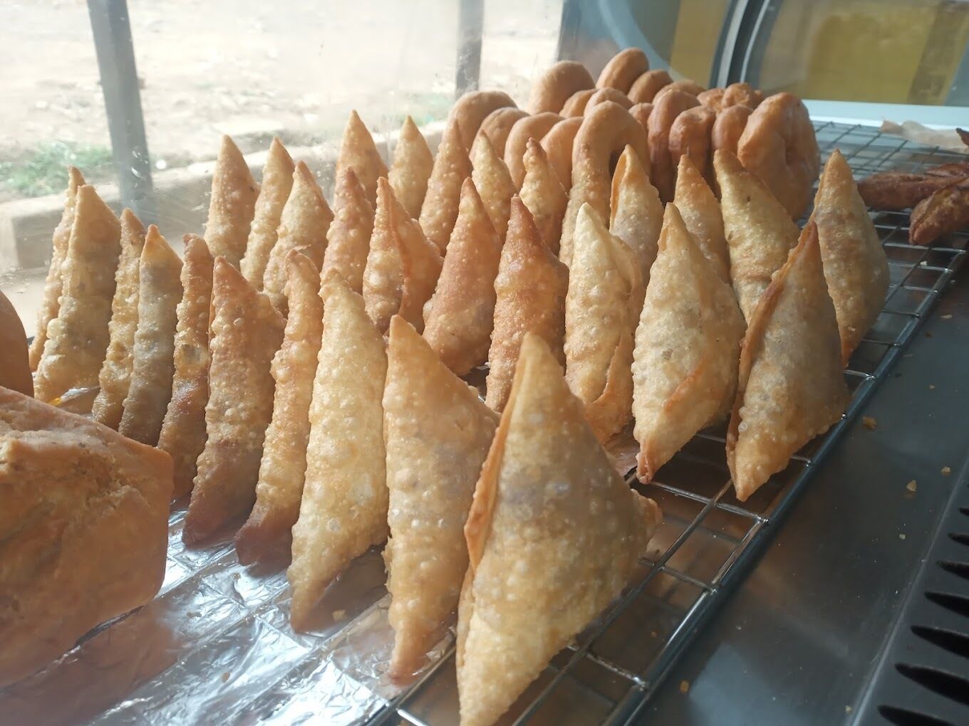 A variety of fried snacks arranged on a rack.