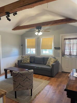 Premier Cabin, Garden View | Living area | 36-inch Smart TV with digital channels - The Outpost (Grand Rivers)