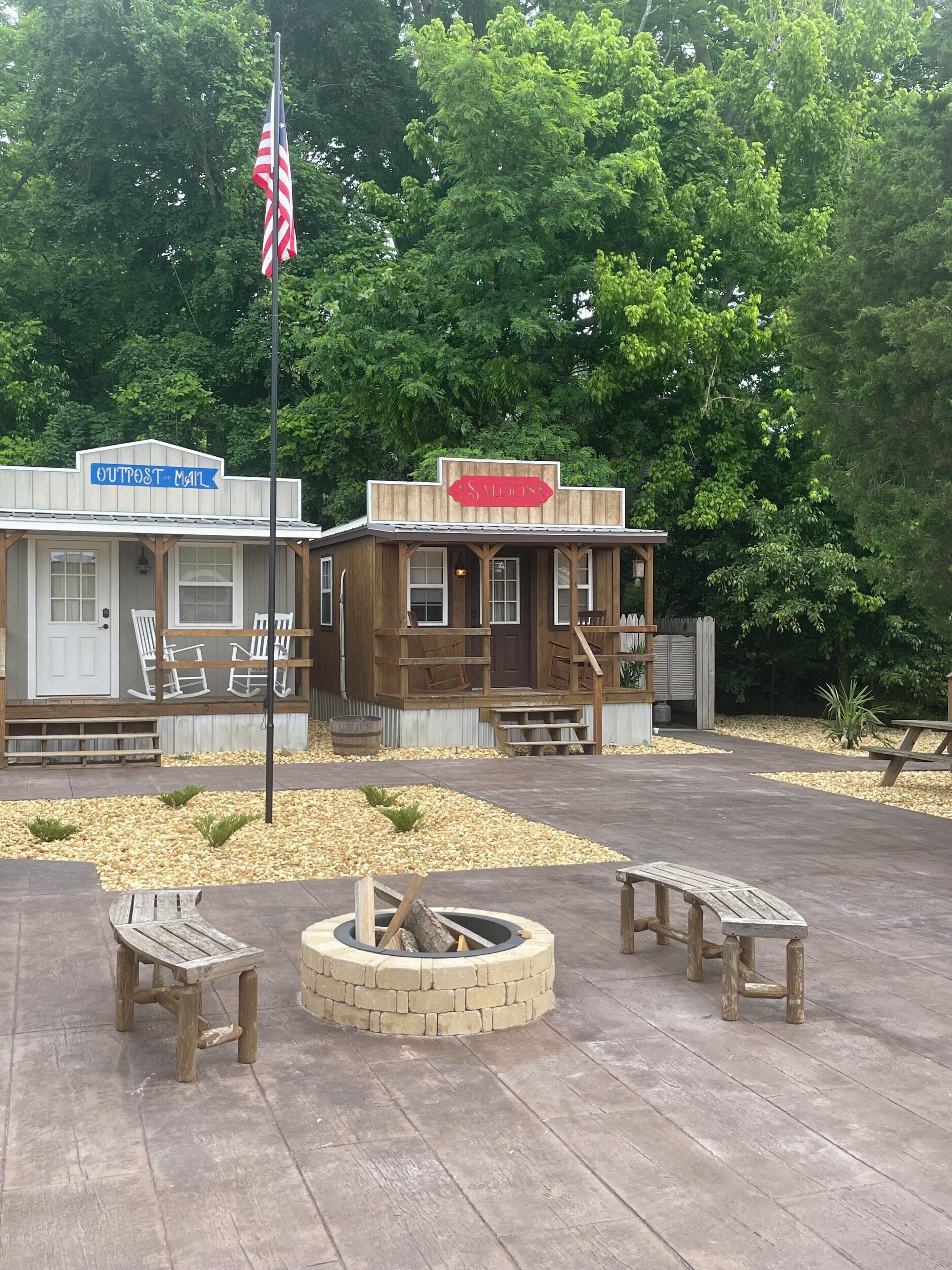 A rustic building with a sign reading "OUTPOST Mail" and "SLOAN."