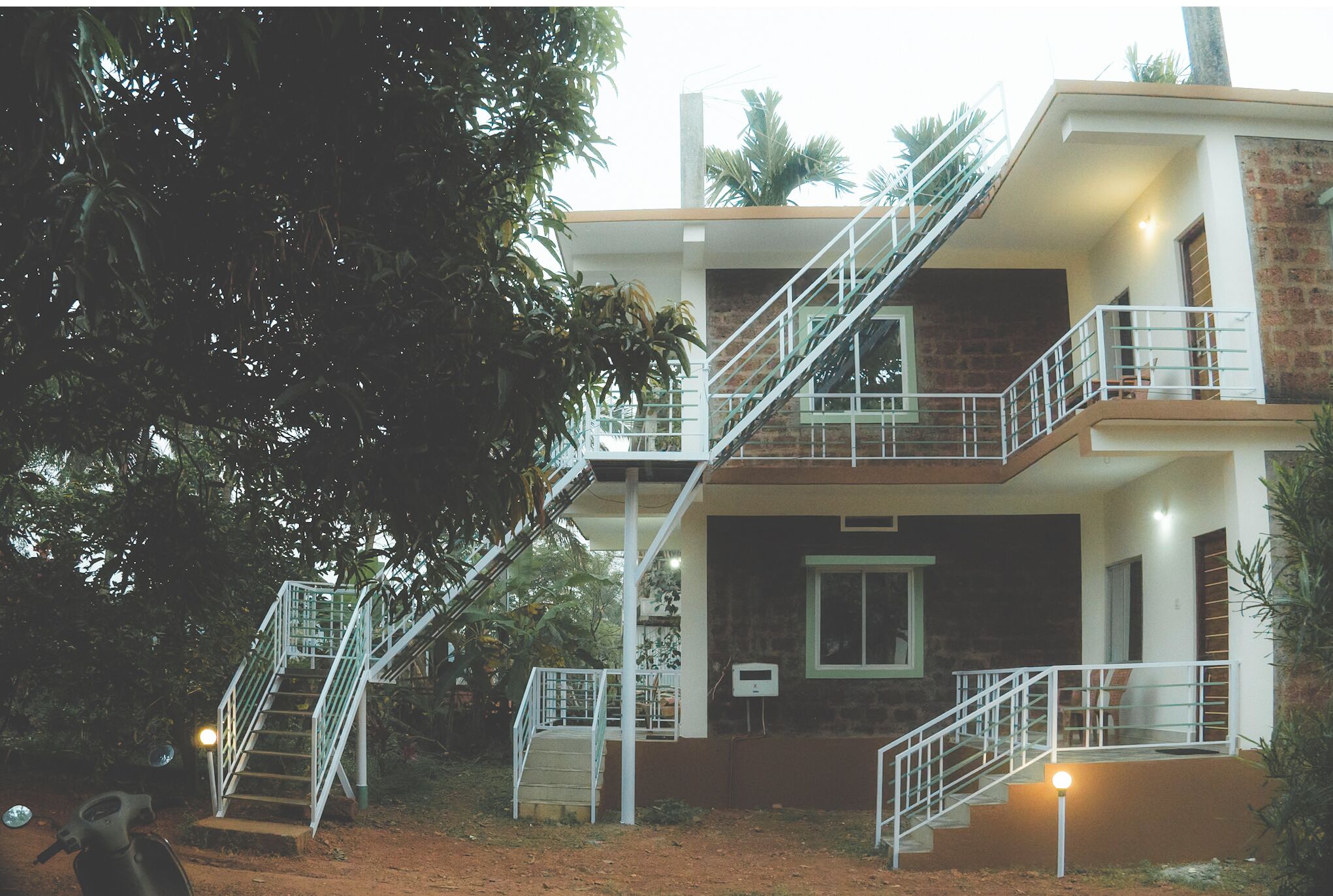 A two-story building with a staircase and a balcony.