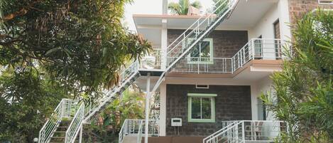 A two-story building with a staircase leading to the upper floor.