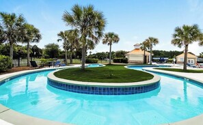 A swimming pool with a circular design, surrounded by palm trees and lounge chairs. - 3 Beds, 2.5 Baths+Fenced Yard for Family & Pets (Port Wentworth)