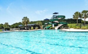 A swimming pool with a water slide and lounge chairs. - 3 Beds, 2.5 Baths+Fenced Yard for Family & Pets (Port Wentworth)