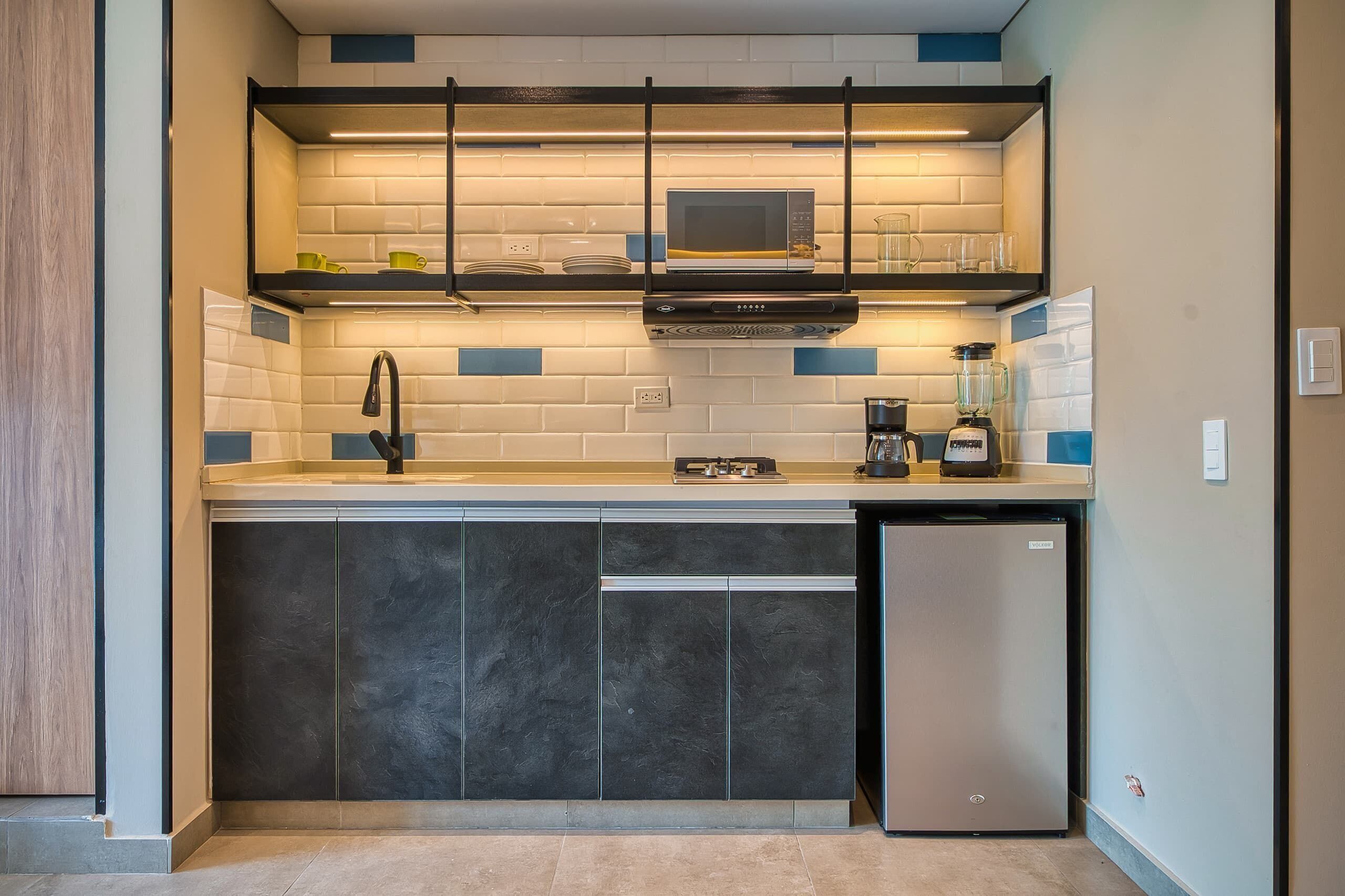 A compact kitchen with a microwave, stove, and dishwasher.