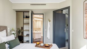 A hotel room with a bed, a tray with breakfast, a bathroom, and a hallway. - Vivre Cannes (Cannes)