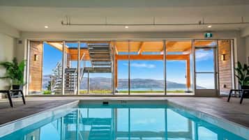 A swimming pool with a view of a mountain and a clear sky.