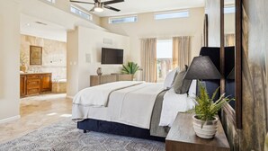 A spacious bedroom with a large bed, a ceiling fan, a flat-screen TV, and a potted plant. - Scottsdale Luxury Villa w/ Pool, Hot Tub, Pickleball, Mini-Golf, Basketball (Scottsdale)