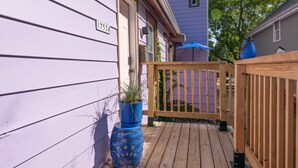 A wooden deck with a blue planter and a wooden fence. - Entire Designer Building, Sleeps 13 (Milwaukee)