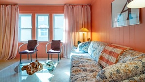 A room with a sofa, two chairs, a glass coffee table, and a lamp. - Entire Designer Building, Sleeps 13 (Milwaukee)