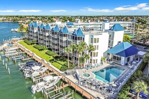 A hotel with multiple buildings, a marina with boats, and a swimming pool. - 2 Bedroom Condo Marco Island! (Marco Island)
