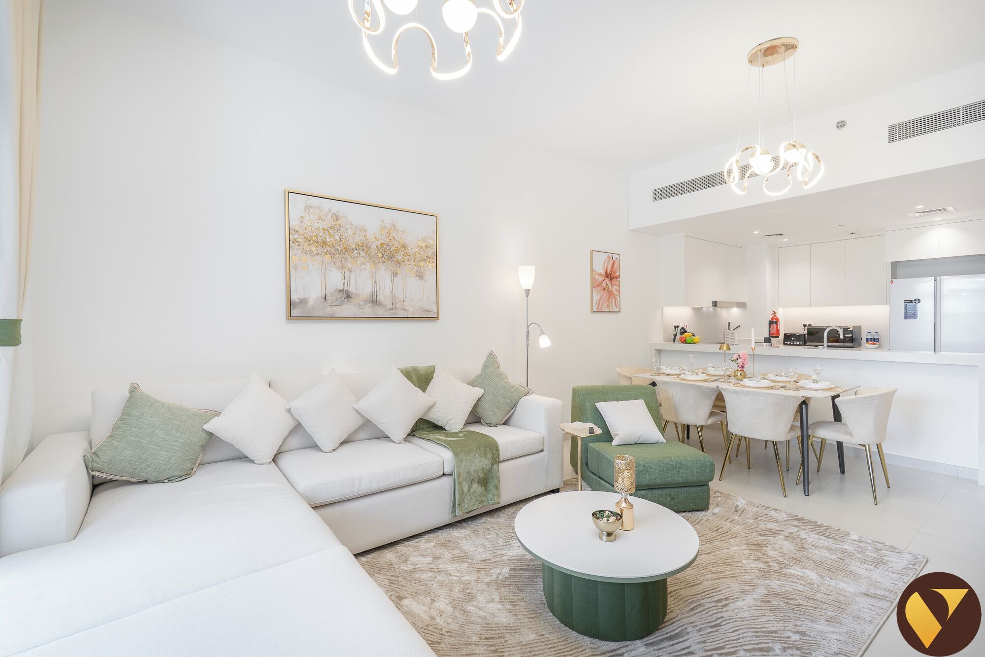 A modern living room with a sofa, coffee table, and dining area.