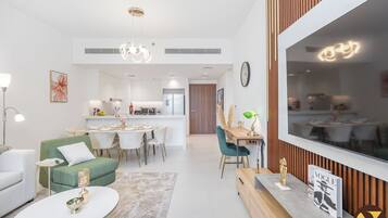 Luxury Apartment, Balcony, Pool View | Living area | 65-inch Smart TV with cable channels