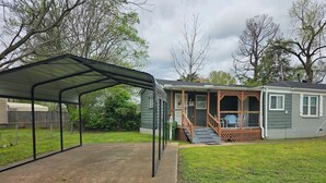 A single-story house with a covered patio area and a small porch. - Bluff City Studio: B (Millington)