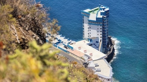 A coastal hotel with a prominent tower structure, a flat-roofed building, and a view of the sea. - Atlantic View Studio in Mesa del Mar (Mesa del Mar)