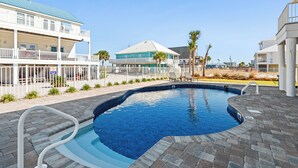 A swimming pool with a brick deck, surrounded by a white fence and palm trees. - 🏖️Nirvana in Navarre | Stunning 3BR Home w/ Private Pool + Walk to Beach🏖️ (Navarre)