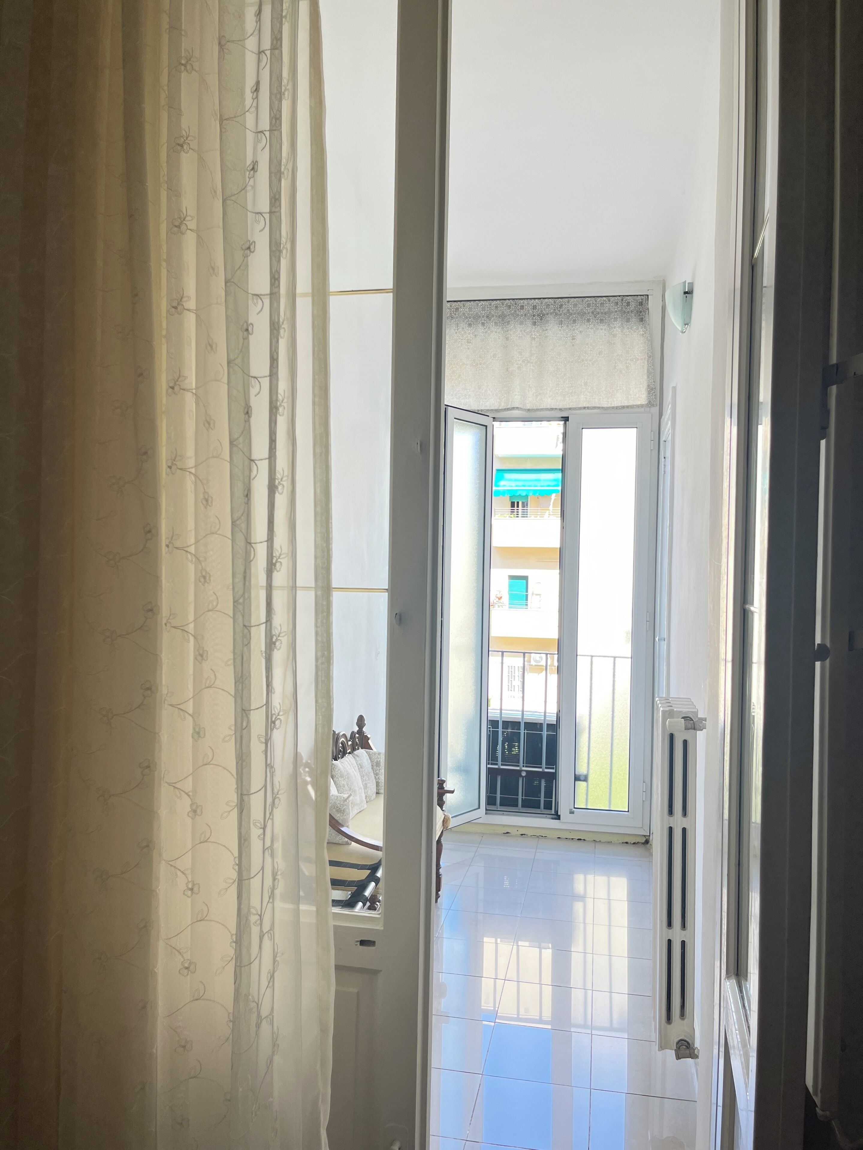 Ein Gang, der zu einem Balkon mit Blick auf ein Gebäude führt.