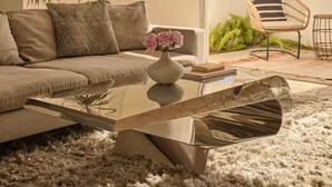 A modern living room with a sofa, coffee table, and decorative plants. - Besveca House - Modern Zen (Palm Springs)