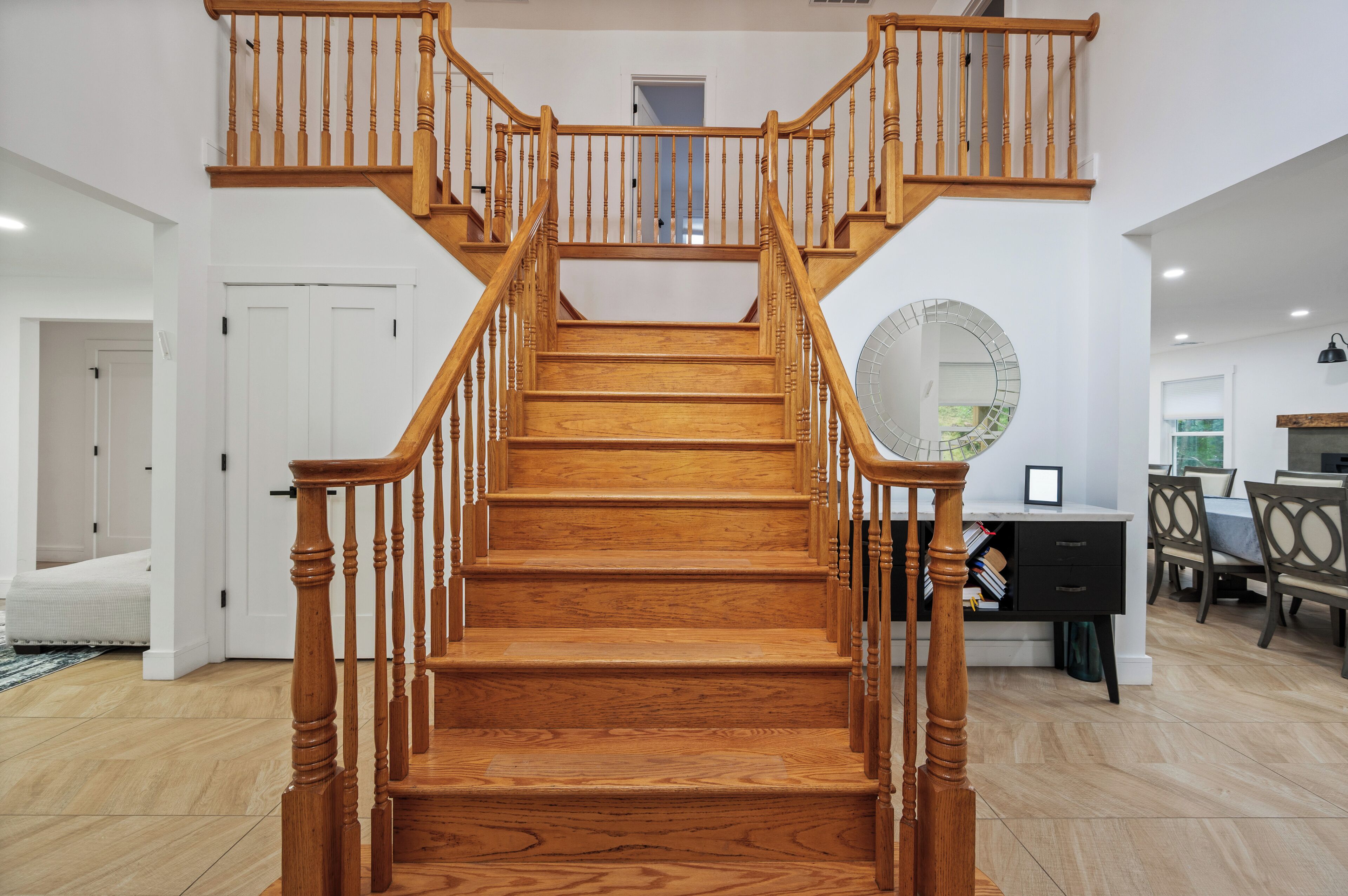 A wooden staircase with a handrail, leading to an upper floor.