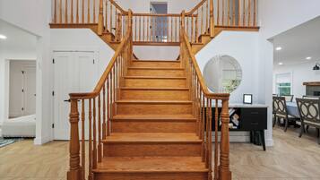 A wooden staircase with a handrail, leading to an upper floor.
