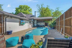 A backyard with a swimming pool, outdoor seating, and a covered patio area. - Charming Oasis Hot Tub PingPong PS5 EV Sleeps 16+ (McKinney)