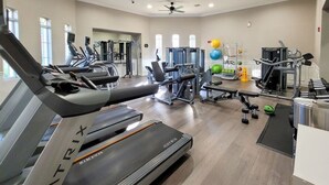 A modern gym with treadmills, weight machines, and exercise balls. - Last Minute Disney Getaway! Luxury Condo with Private Balcony. Book Now! #114247 (Orlando)