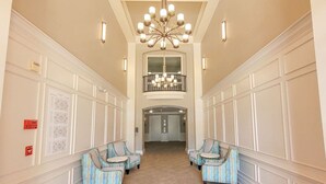 A hotel lobby with a high ceiling, a chandelier, and a view of the upper floor. - Last Minute Disney Getaway! Luxury Condo with Private Balcony. Book Now! #114247 (Orlando)