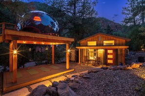 A wooden gazebo with string lights and a glass dome structure. - Stargazer’s Sanctuary • Observatory Dome Retreat: Sauna & Hot Tub (Sedona)