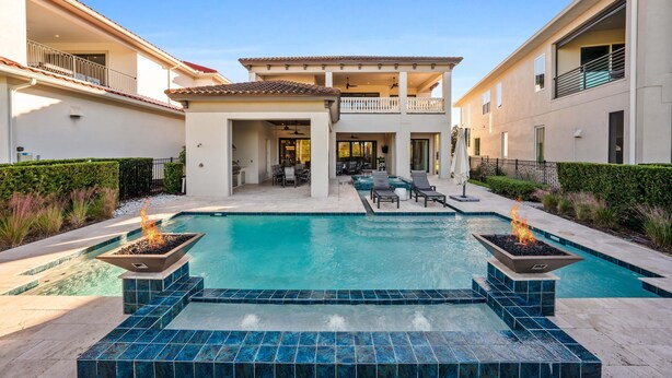 A residential property with a swimming pool, outdoor seating, and a two-story building. - Last Minute Disney Getaway! Private Pool & Home Theater. Book Now! #158253 (Orlando)