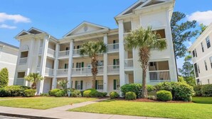 A multi-story building with balconies and a central courtyard. - Top-Floor River Oaks Escape  2BR, 2BA (Myrtle Beach)