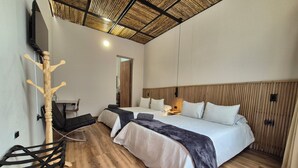A modern hotel room with a large bed, a wooden headboard, a TV mounted on the wall, and a wooden ceiling. - Pepe's House Usaquén Bogotá -Small Hotel (Bogotá)
