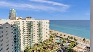 A high-rise hotel with multiple balconies overlooking a beach and ocean. - Oceanview Penthouse Pool Beach Access (Hollywood)