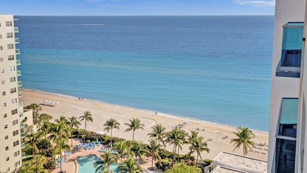 A beach view with a pool and palm trees. - Oceanview Penthouse Pool Beach Access (Hollywood)