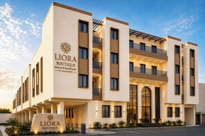A multi-story hotel building with a prominent sign reading 'LIORA BOUTIQUE Hotels & Residences by Asasmakeen.' - Liora Boutique Hotel (Riyadh)
